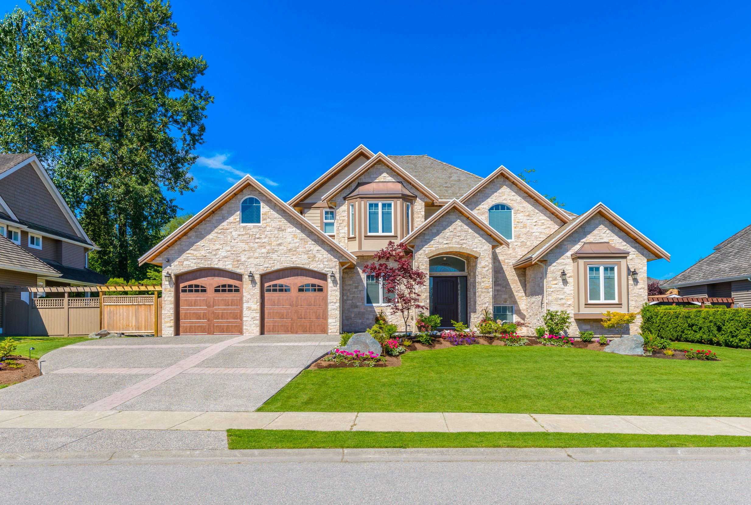 Luxury House With Nicely Landscaped Front Yard and Driveway